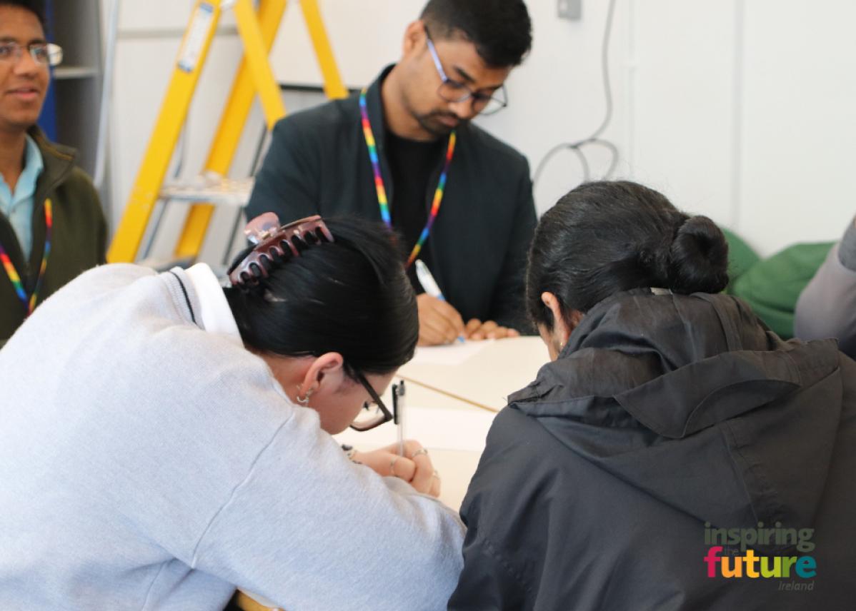 People writing at a table